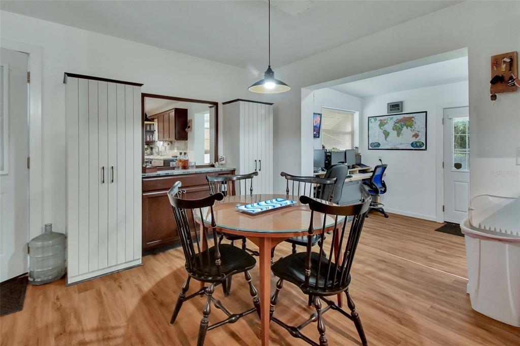 22040 Blue Creek Lodge Road Astor, FL 32102 - Photo 12 of 42 a view of a dining room with furniture and wooden floor