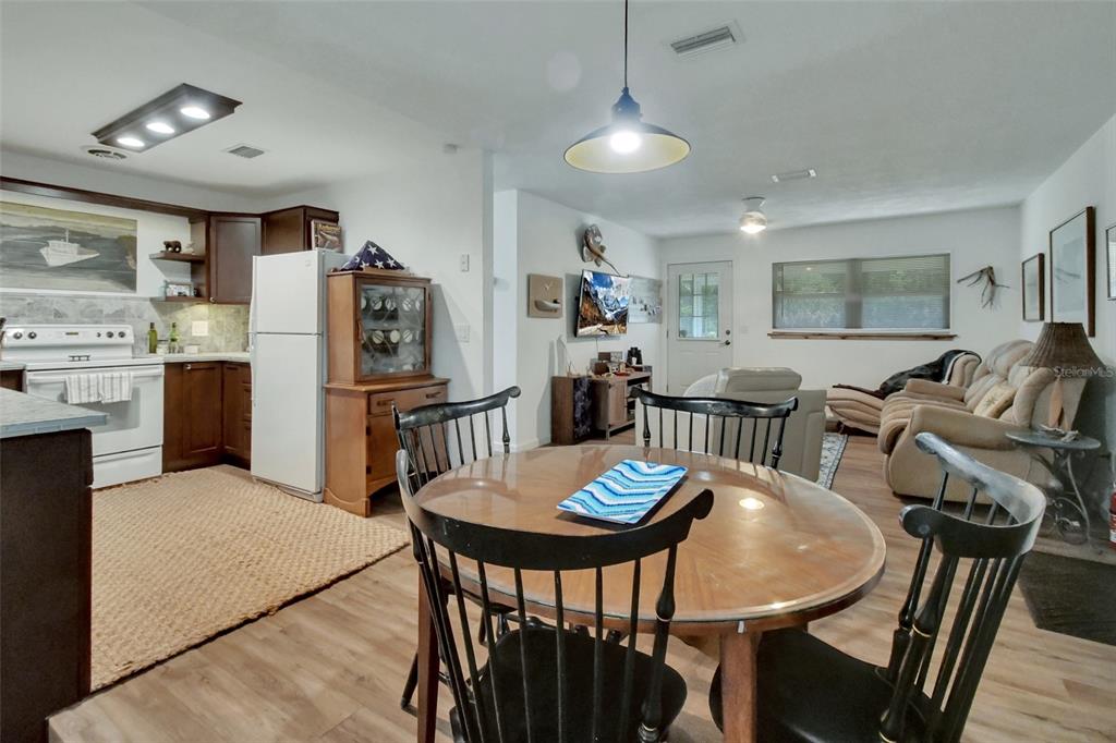 22040 Blue Creek Lodge Road Astor, FL 32102 - Photo 15 of 42 a view of a dining room with furniture and a kitchen