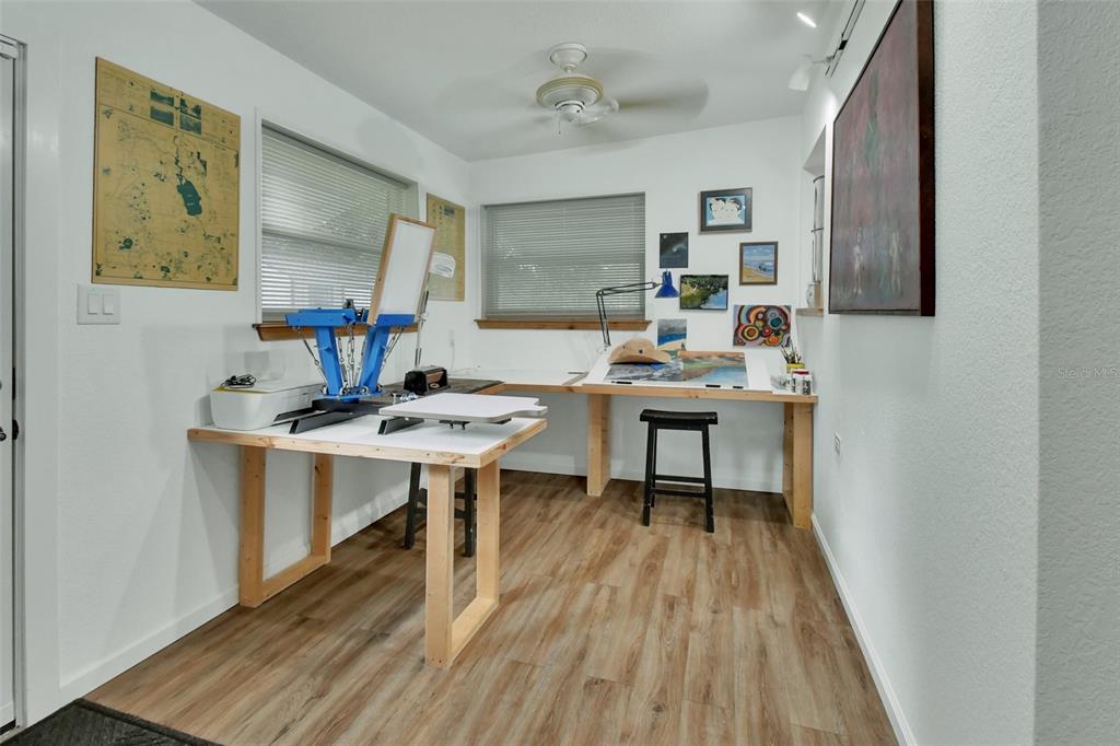 22040 Blue Creek Lodge Road Astor, FL 32102 - Photo 16 of 42 a room with a table chairs and wooden floor