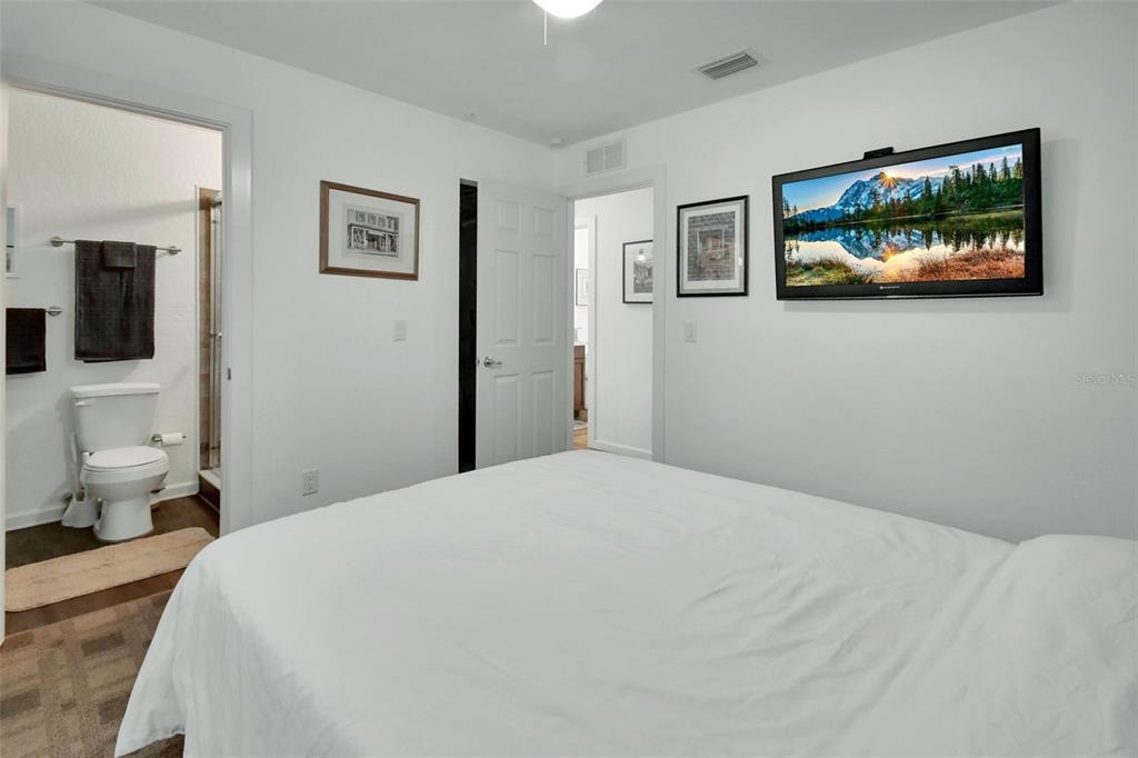 22040 Blue Creek Lodge Road Astor, FL 32102 - Photo 19 of 42 a bedroom with a bed and a flat screen tv