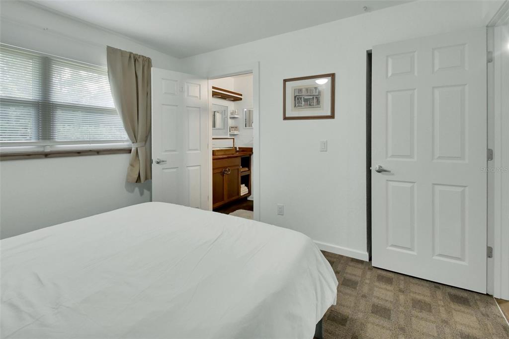 22040 Blue Creek Lodge Road Astor, FL 32102 - Photo 20 of 42 a bedroom with a bed and a window