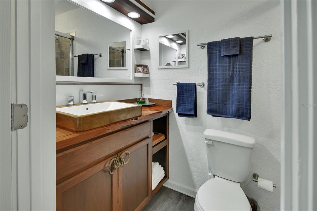 22040 Blue Creek Lodge Road Astor, FL 32102 - Photo 21 of 42 a bathroom with a sink a toilet and mirror