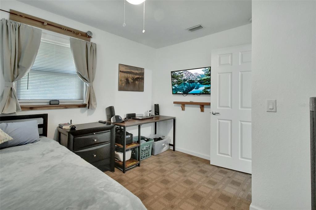 22040 Blue Creek Lodge Road Astor, FL 32102 - Photo 24 of 42 a view of a workspace with furniture and a window