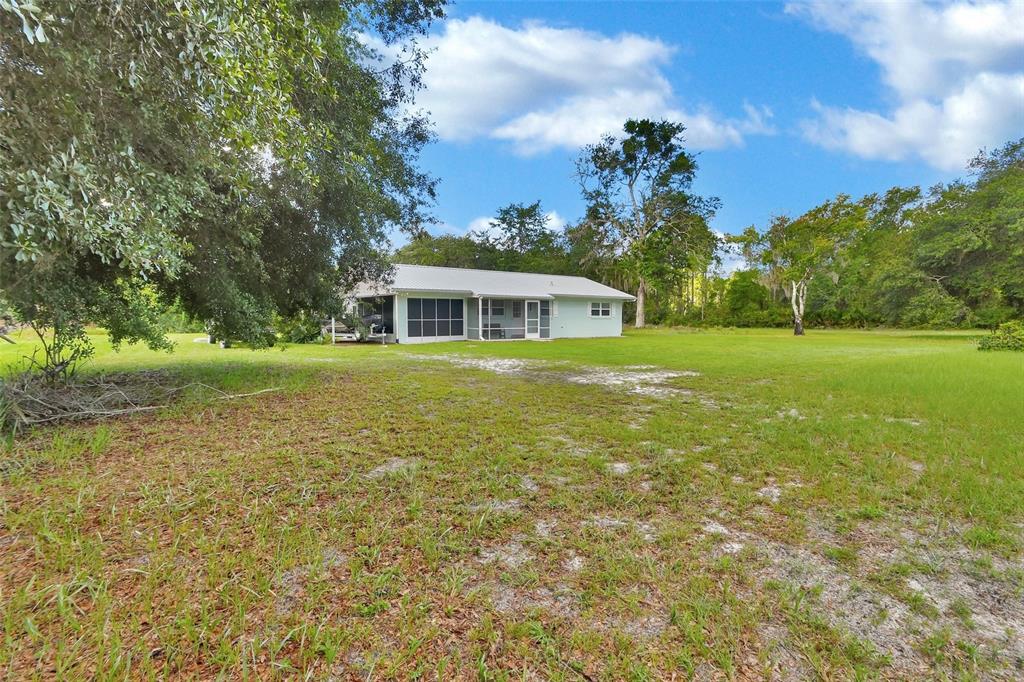 22040 Blue Creek Lodge Road Astor, FL 32102 - Photo 29 of 42 a view of a house with a big yard