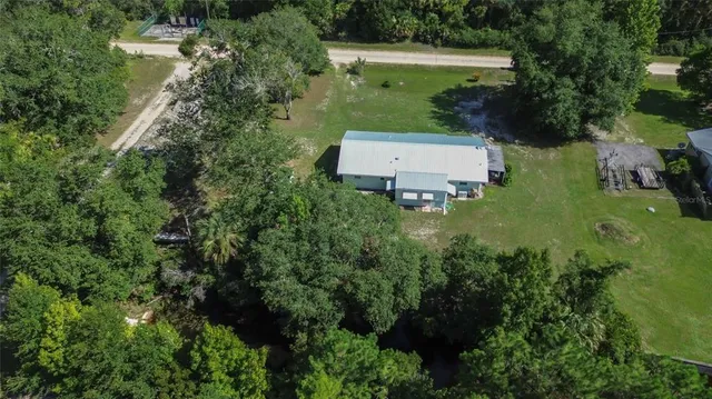 an aerial view of a house with a yard