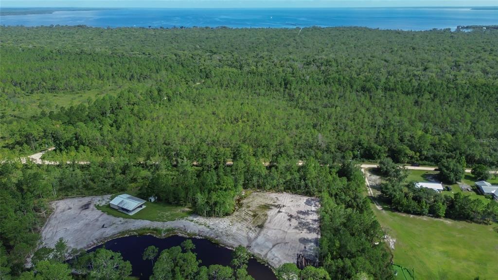 22040 Blue Creek Lodge Road Astor, FL 32102 - Photo 41 of 42 a view of a lush green field