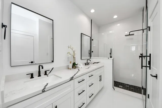 a bathroom with double vanity sink and mirror