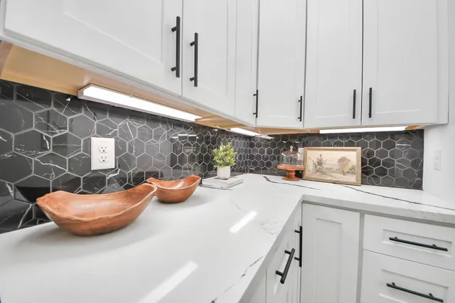 a kitchen with a sink and white cabinets