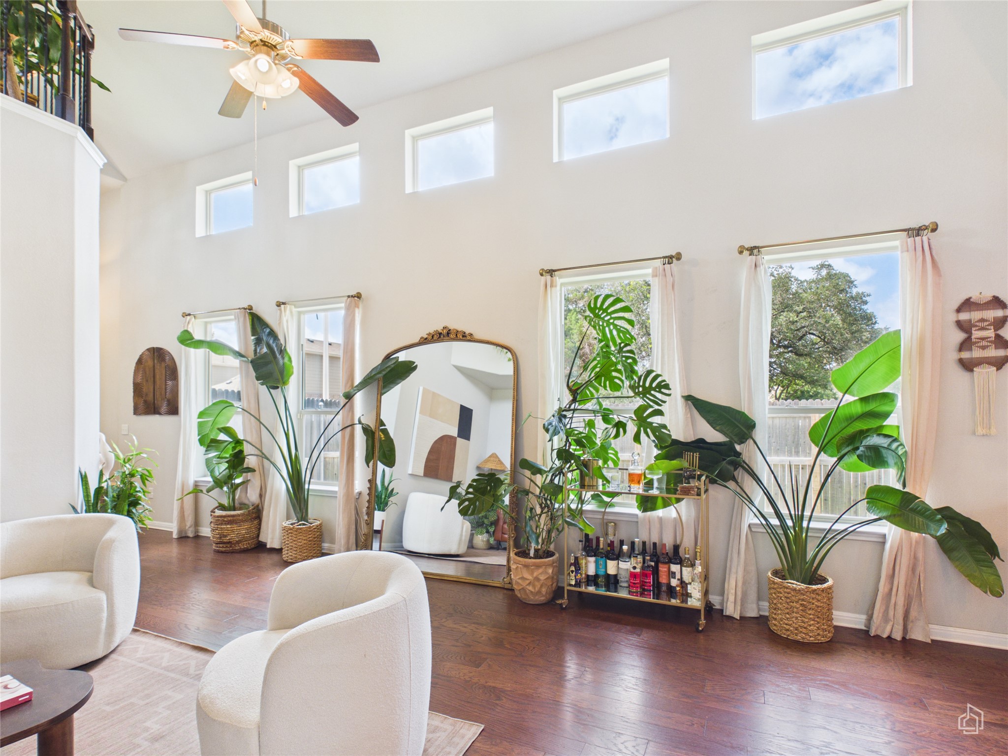 9310 Tanager Way Austin, TX 78748 - Photo 12 of 32 Hardwood floors and lofty ceilings elevate this inviting, naturally illuminated living space.