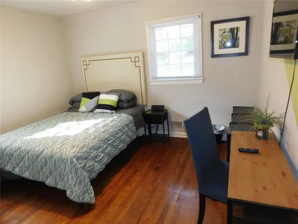 a workspace room with furniture and wooden floor