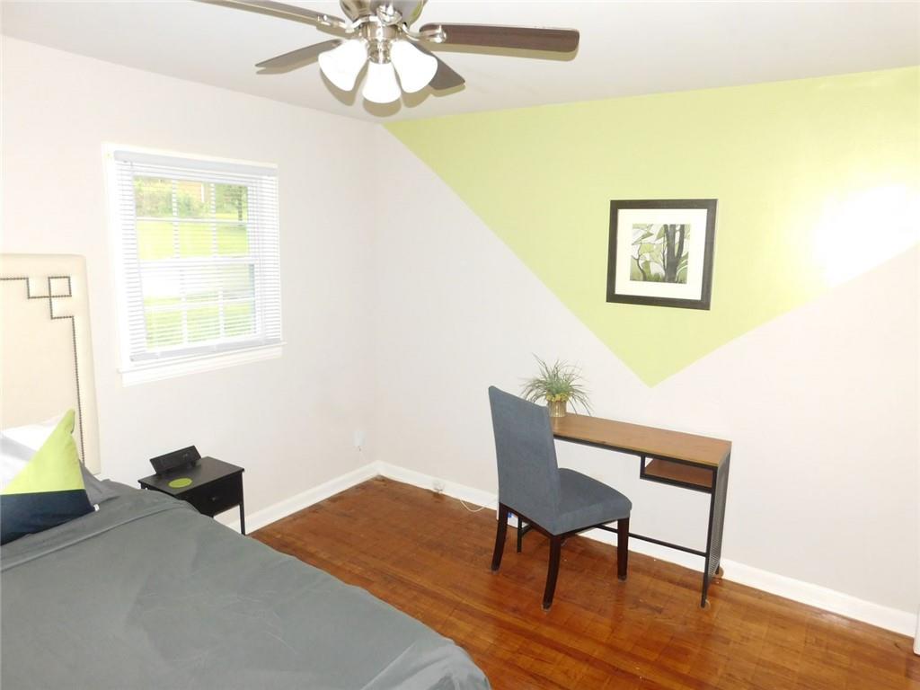 507 Pineridge Road Forest Park, GA 30297 - Photo 12 of 14 a workspace room with furniture and wooden floor