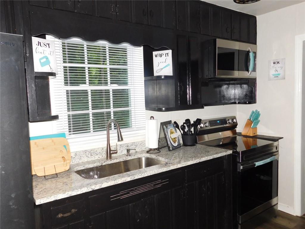 507 Pineridge Road Forest Park, GA 30297 - Photo 13 of 14 a kitchen with a sink and a microwave