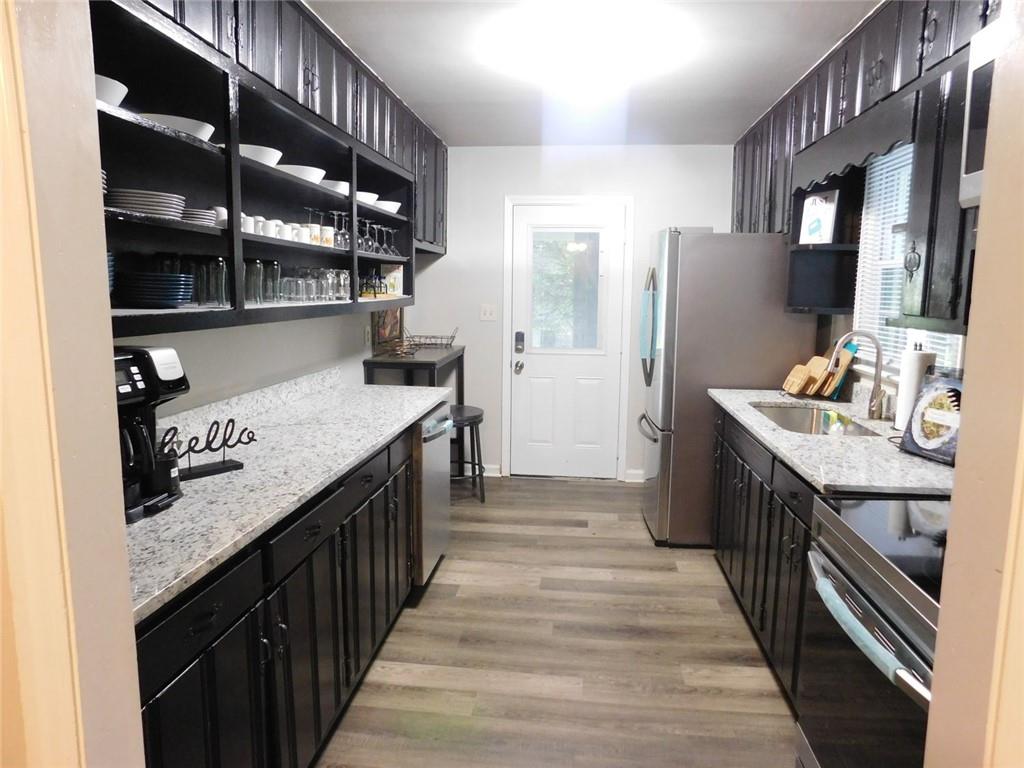 507 Pineridge Road Forest Park, GA 30297 - Photo 14 of 14 a kitchen with granite countertop a sink and a refrigerator
