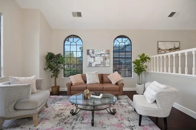 a living room with furniture a flat screen tv and a fireplace