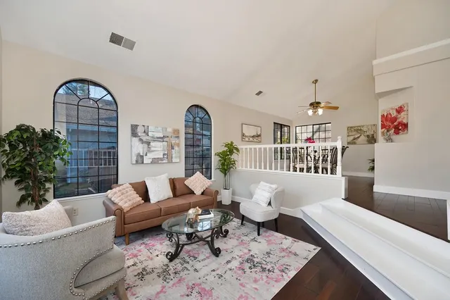 a kitchen with stainless steel appliances granite countertop a stove top oven a sink a dining table and chairs