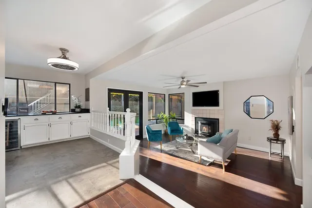 a living room with furniture a fireplace and a flat screen tv