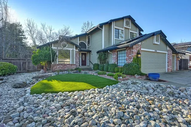 a front view of a house with swimming pool having outdoor seating