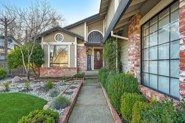 a front view of a house with garden