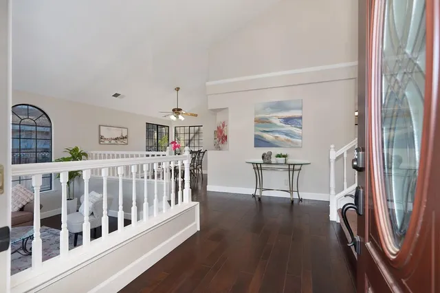 a living room with furniture a rug and a window