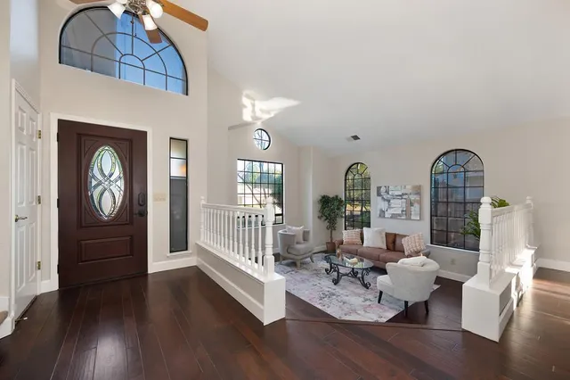 a living room with furniture and a potted plant