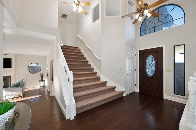 a view of a dining room with furniture and a chandelier