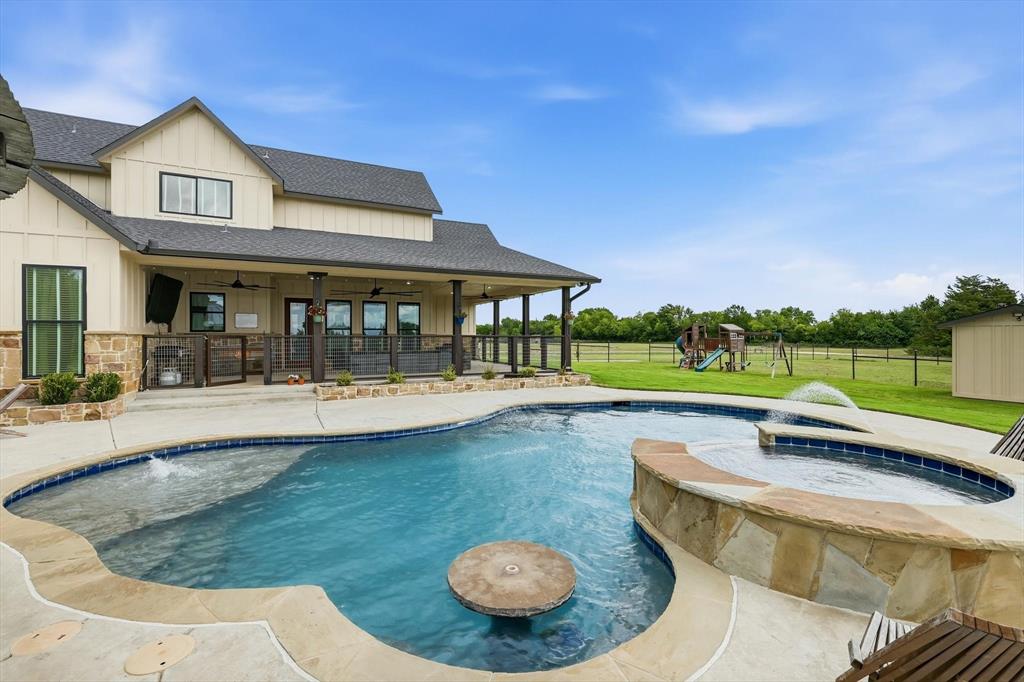 6020 Honeysuckle Road Midlothian, TX 76065 - Photo 30 of 39 Resort-style backyard featuring a freeform swimming pool with integrated spa and water features