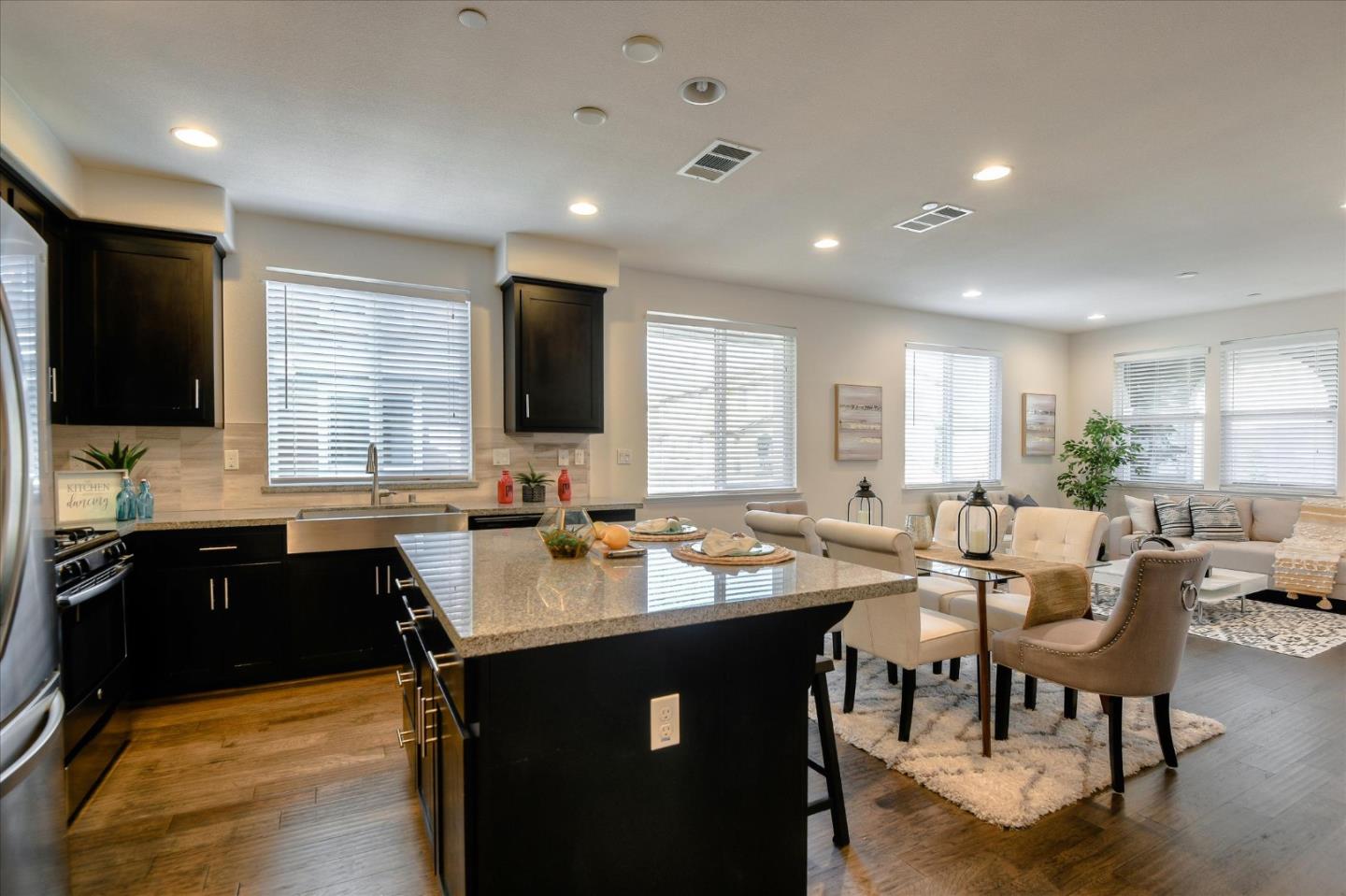 1915 McCandless Drive Milpitas, CA 95035 - Photo 2 of 28 a kitchen with a dining table chairs and a flat screen tv