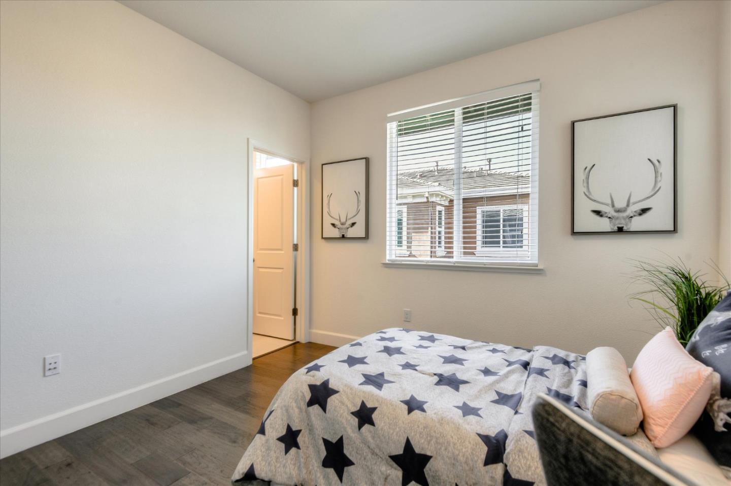 1915 McCandless Drive Milpitas, CA 95035 - Photo 21 of 28 a bedroom with a bed and wooden floor