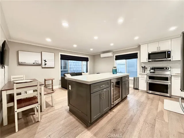 a kitchen with stainless steel appliances kitchen island granite countertop a stove top oven and a refrigerator