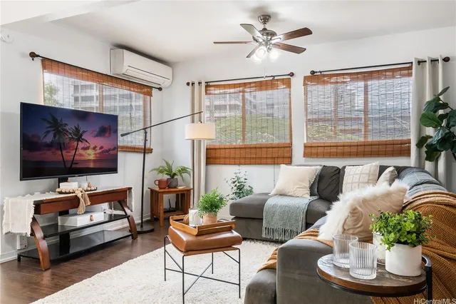 a living room with furniture a large window and a flat screen tv