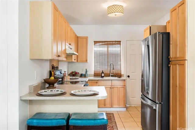 a kitchen with a refrigerator and a stove