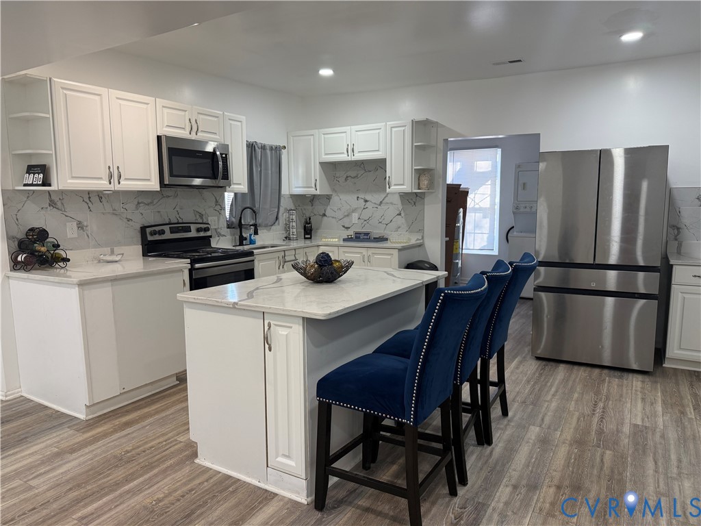 1340 Rome Street Petersburg, VA 23803 - Photo 14 of 35 a kitchen with a table chairs refrigerator and microwave