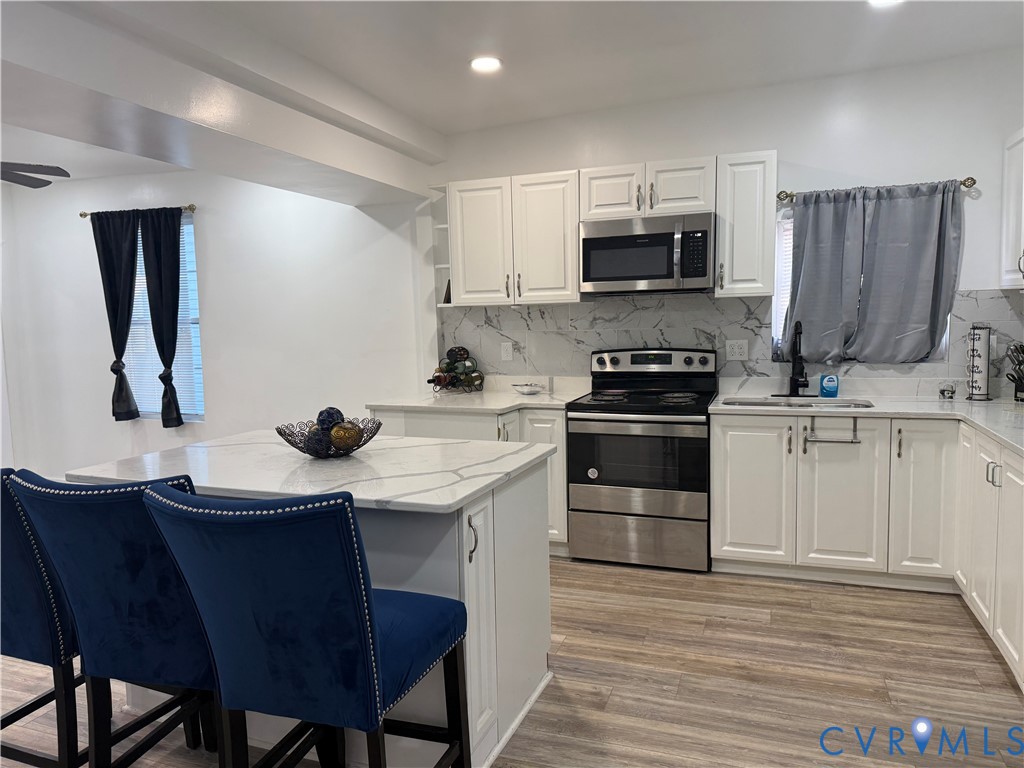 1340 Rome Street Petersburg, VA 23803 - Photo 15 of 35 a kitchen with a sink appliances and cabinets