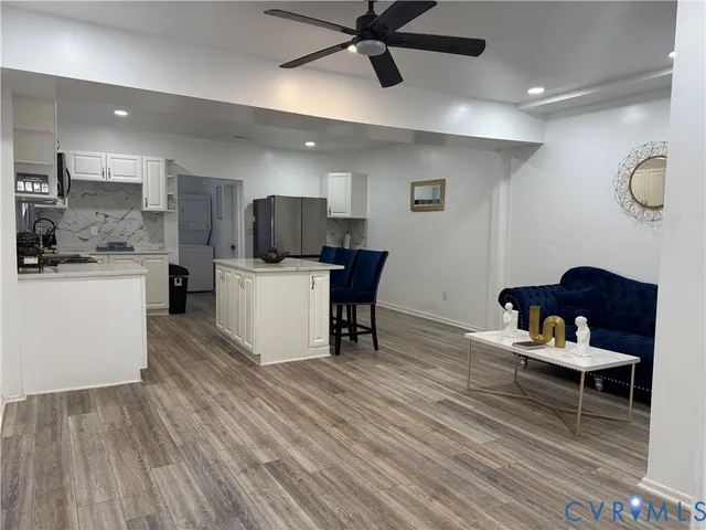 a living room with furniture and a wooden floor