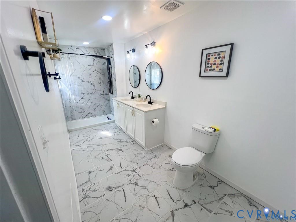 1340 Rome Street Petersburg, VA 23803 - Photo 21 of 35 a bathroom with a granite countertop toilet sink and mirror