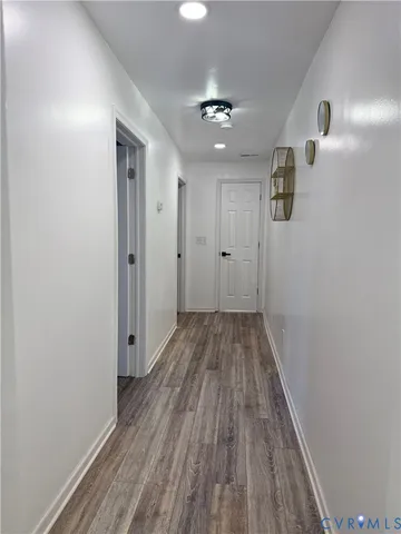 a view of a room with wooden floor