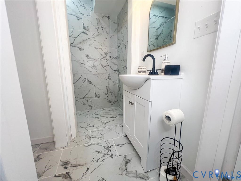 1340 Rome Street Petersburg, VA 23803 - Photo 7 of 35 a bathroom with a sink and mirror with toilet