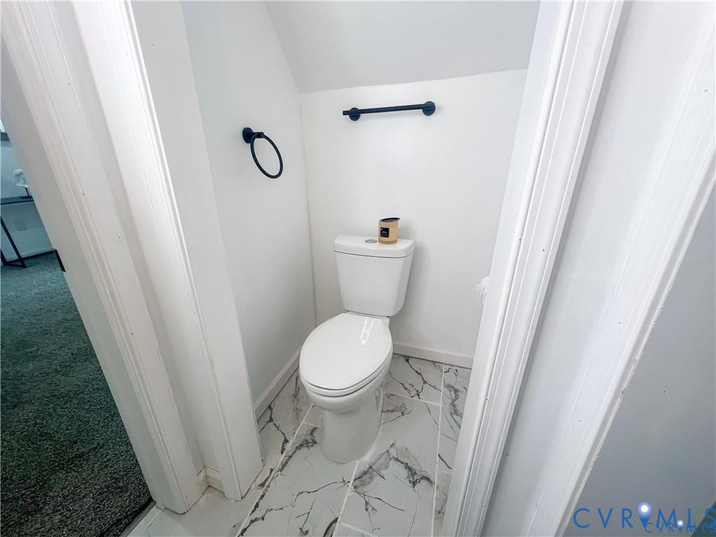 1340 Rome Street Petersburg, VA 23803 - Photo 9 of 35 a white toilet sitting next to a wooden floor