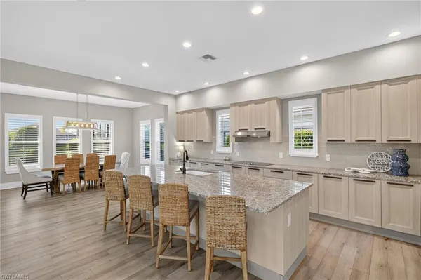 a large kitchen with lots of counter space and windows