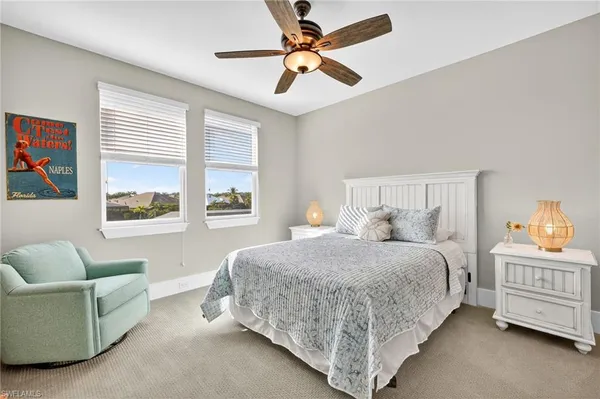 a bedroom with a bed couch and window