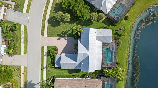 an aerial view of a house with garden space and street view