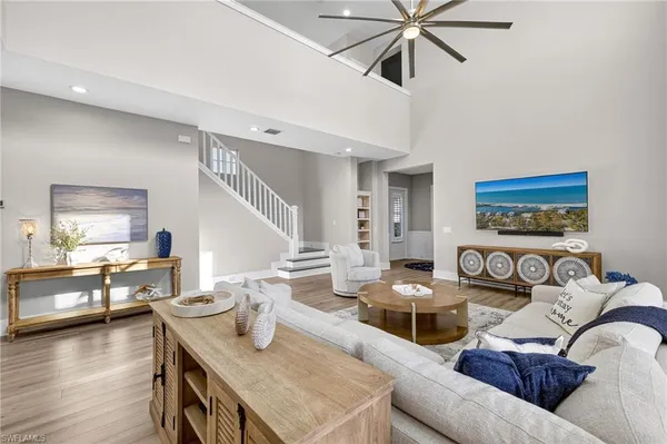 a living room with furniture and wooden floor