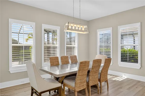a view of a dining room with furniture and windows