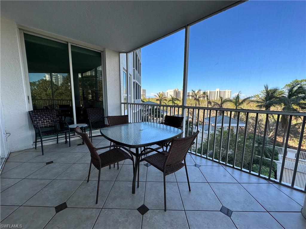 325 Dunes Boulevard, Unit 306 Naples, FL 34110 - Photo 28 of 40 a view of a chairs and table in the patio