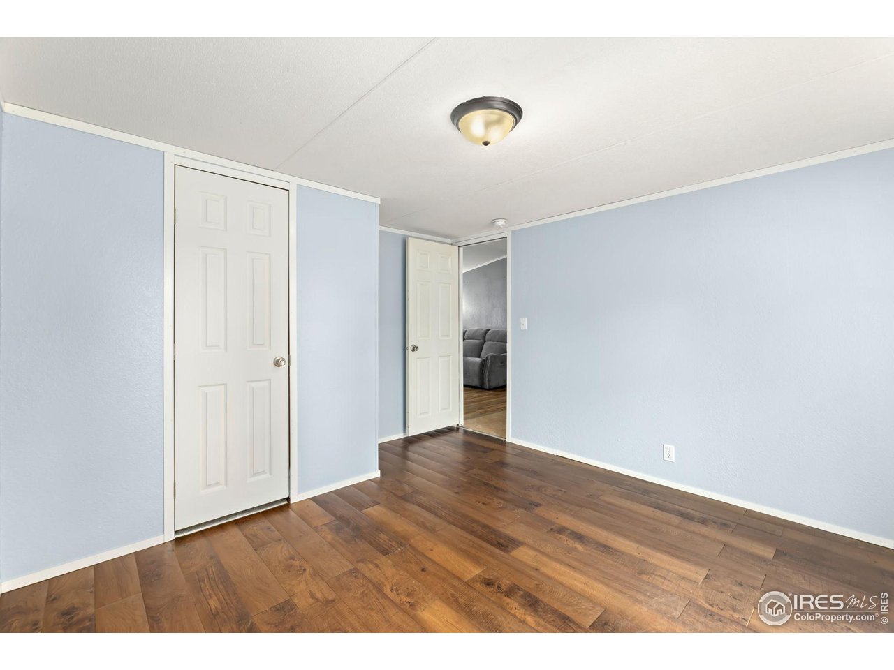 218 Grape Street, Unit 29 Hudson, CO 80642 - Photo 16 of 26 a view of an empty room with wooden floor