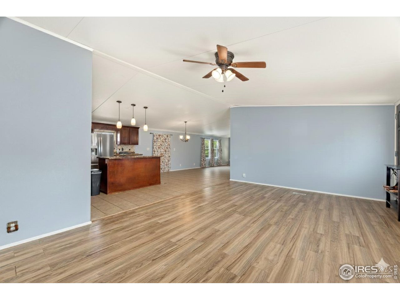 218 Grape Street, Unit 29 Hudson, CO 80642 - Photo 20 of 26 a view of a room with a kitchen and wooden floor