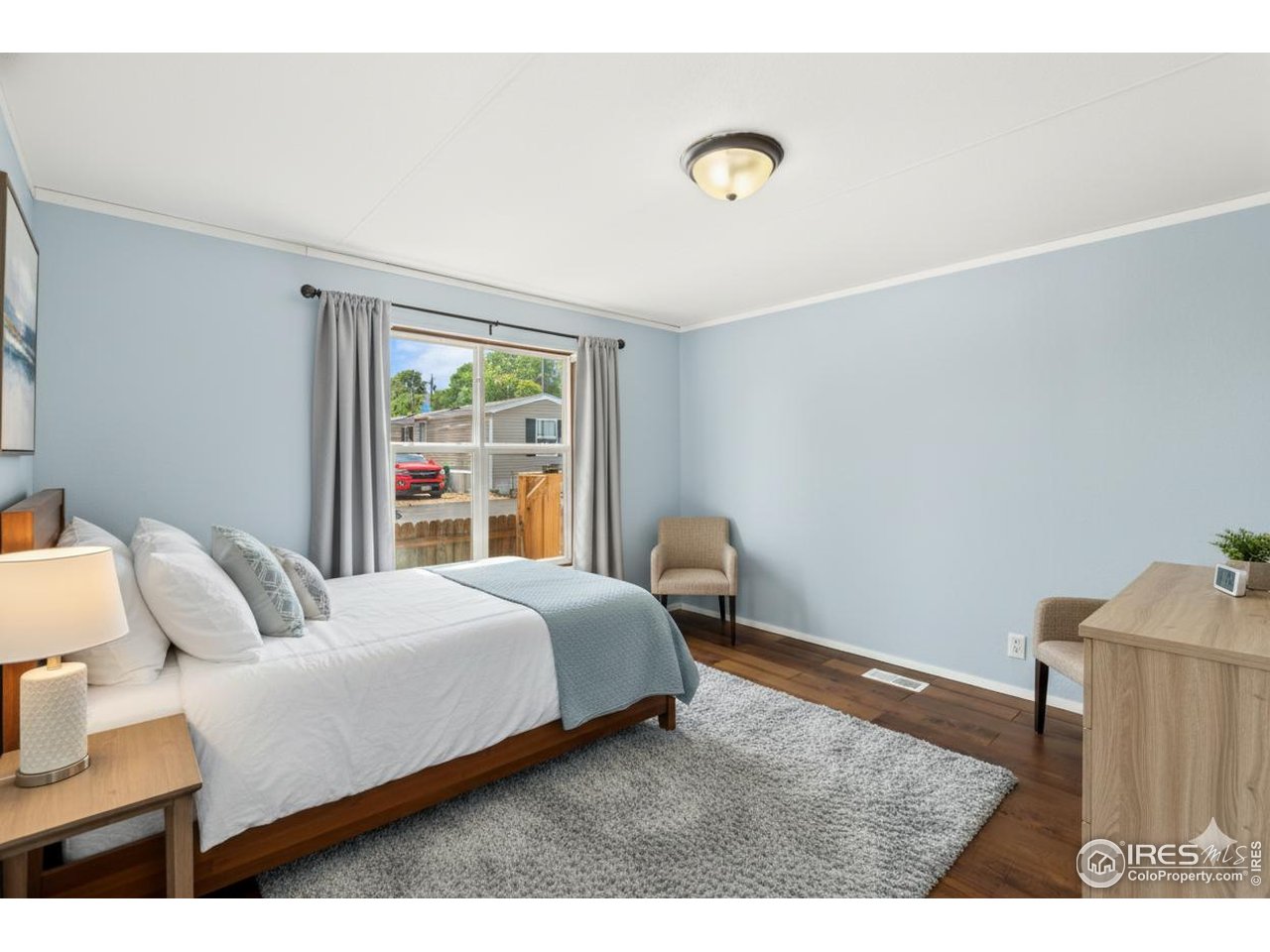 218 Grape Street, Unit 29 Hudson, CO 80642 - Photo 2 of 26 a bedroom with a bed and a window