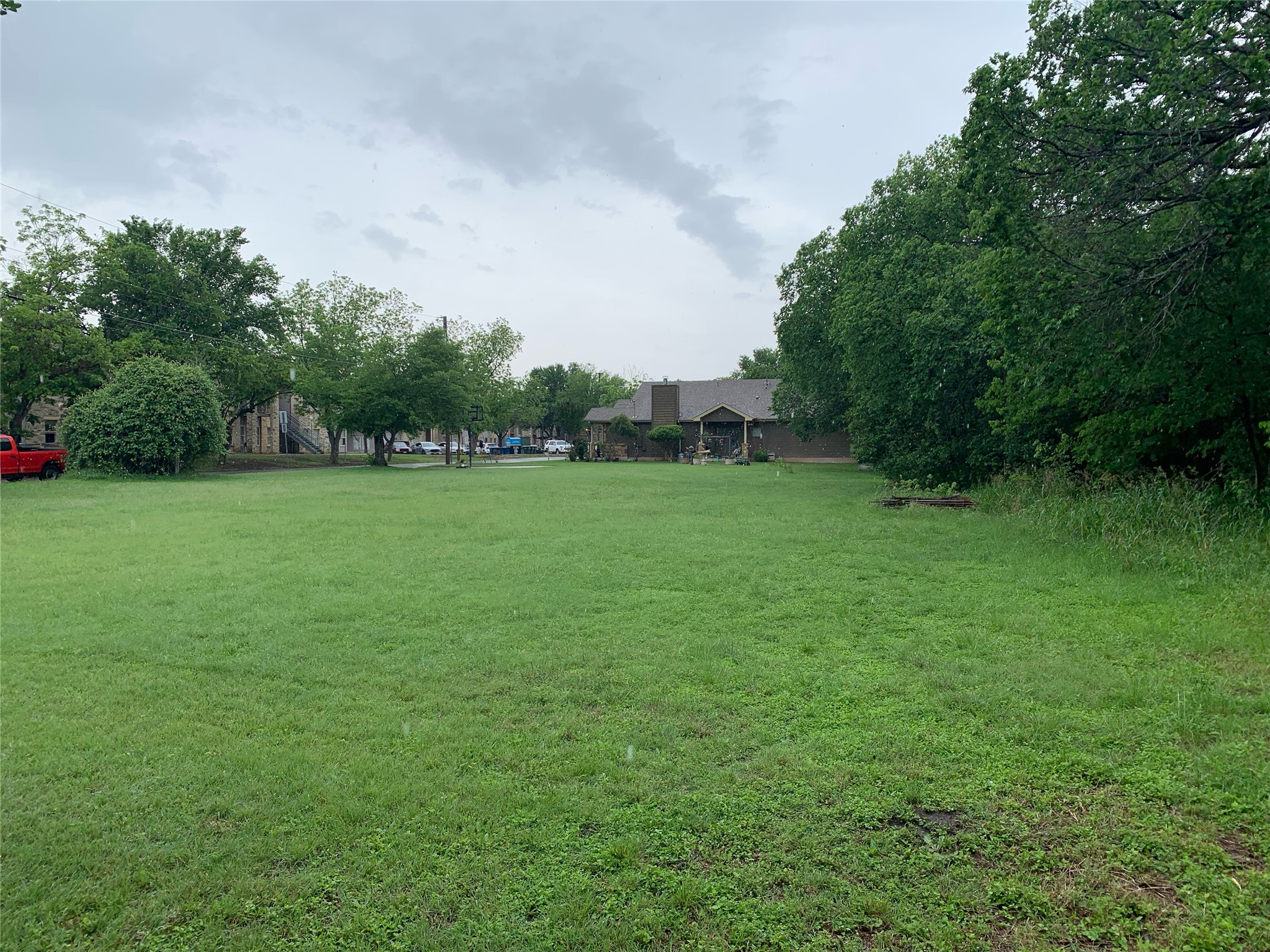 1112 East 8th Street Georgetown, TX 78626 - Photo 2 of 2 a view of a grassy field with trees in the background