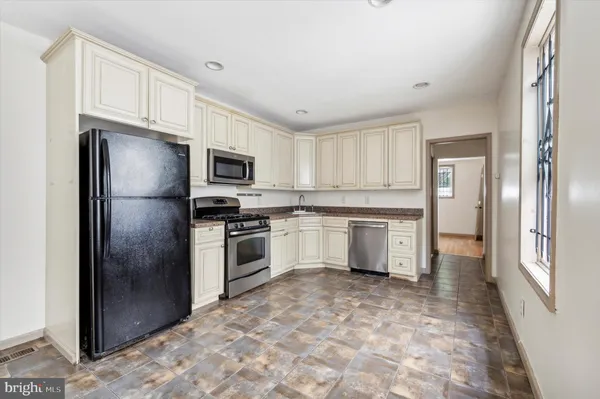 a kitchen with a refrigerator stove and microwave