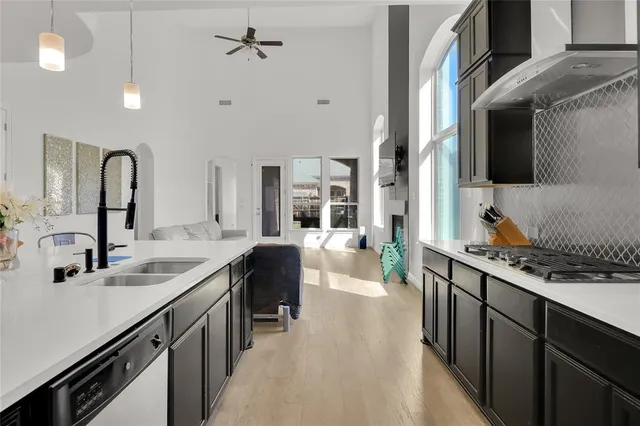 a kitchen with stainless steel appliances a sink stove and cabinets